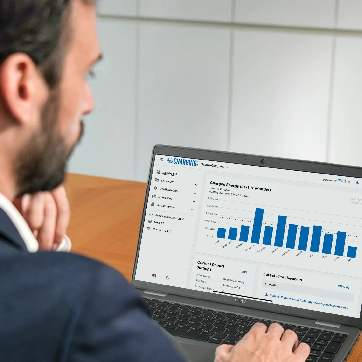 Fleet manager uses Charging4Fleets portal on laptop with NRGkick wallbox for company fleets.